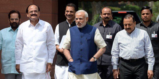 Indian Prime Minister Narendra Modi (C) arrives at Parliament with Ministers of Parliamentary Affairs, Mukhtar Abbas Naqvi (L), Venkaiah Naidu (2L), Rajiv Pratap Rudy (3L) and Jitender Singh (2R) in New Delhi on April 20, 2015.
