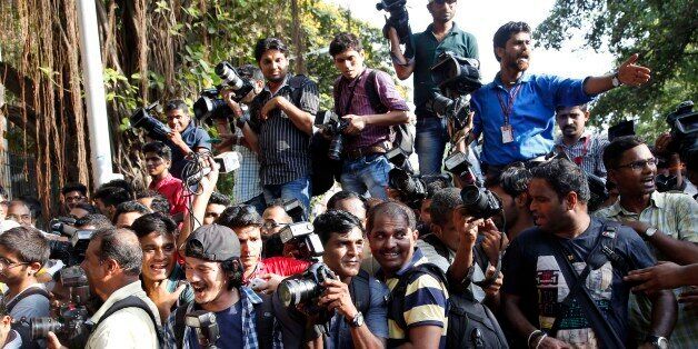 Members of the media jostle for space outside the Mumbai Sessions court during Bollywood actor Salman Khan's verdict in Mumbai, India, Wednesday, May 6, 2015. One of India's biggest and most popular movie stars, Khan, was sentenced to five years in jail Wednesday on charges of driving a vehicle over five men sleeping on a sidewalk and killing one in a hit-and-run case that has dragged for more than 12 years. (AP Photo/Rajanish Kakade)