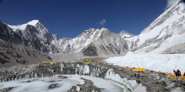 In this Saturday, April 11, 2015 photo, tents are seen set up for climbers on the Khumbu Glacier, with Mount Khumbutse, center, and Khumbu Icefall, right, seen in background, at Everest Base Camp in Nepal. More medical staff has been placed at Mount Everest's base camp, and the government has set up a full-time office tent at the camp, with officials providing security, settling disputes among climbers and monitoring the activities of the hundreds of climbers and guides at the camp. Climbers from four teams have already been issued permits allowing them to climb the 8,850-meter (29,035-foot) peak, another 11 written applications are pending and more applications are expected in the next few days, said Gyanendra Shrestha, an official at Nepal's Mountaineering Department. (AP Photo/Tashi Sherpa)