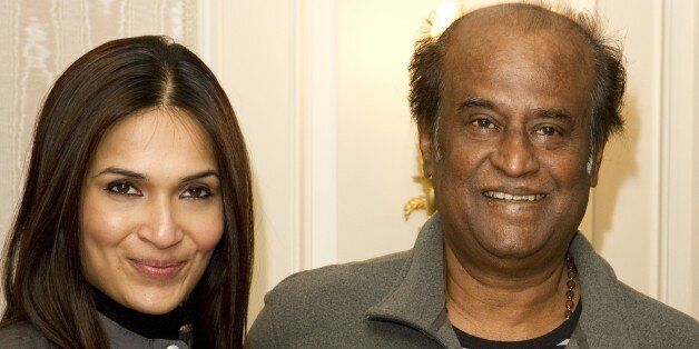 Bollywood director Soundarya (L) and actor Rajinikanth pose on March 31, 2012 in London during the promotion of the film 'Kochadaiyaan.' AFP PHOTO / MIGUEL MEDINA (Photo credit should read MIGUEL MEDINA/AFP/Getty Images)