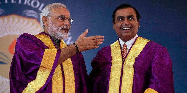 Gujarat state Chief Minister Narendra Modi, left, gestures towards Chairman and Managing Director of Reliance Industries Limited Mukesh Ambani during the convocation ceremony of Pandit Deendayal Petroleum University (PDPU) in Gandhinagar, in the western Indian state of Gujarat, Saturday, Oct. 19, 2013. Modi is Indiaâs main opposition Bharatiya Janata Partyâs candidate for prime minister if it wins national elections next year. (AP Photo/Ajit Solanki)