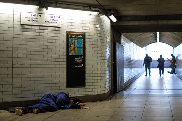 A homeless man sleeps in Westminster station. 