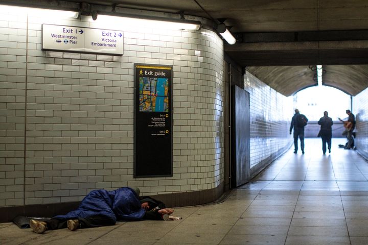 A homeless man sleeps in Westminster station. 