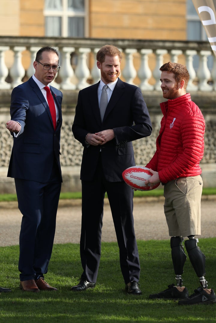 Prince Harry with Jon Dutton (left), chief executive of the Rugby League World Cup 2021, and Leeds Rhino player James Simpson (right) in the Buckingham Palace gardens.