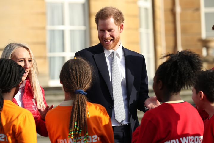 The Duke of Sussex visits with children playing rugby in the Buckingham Palace gardens, as he hosts the Rugby League World Cup 2021 draws on Jan. 16, 2020.