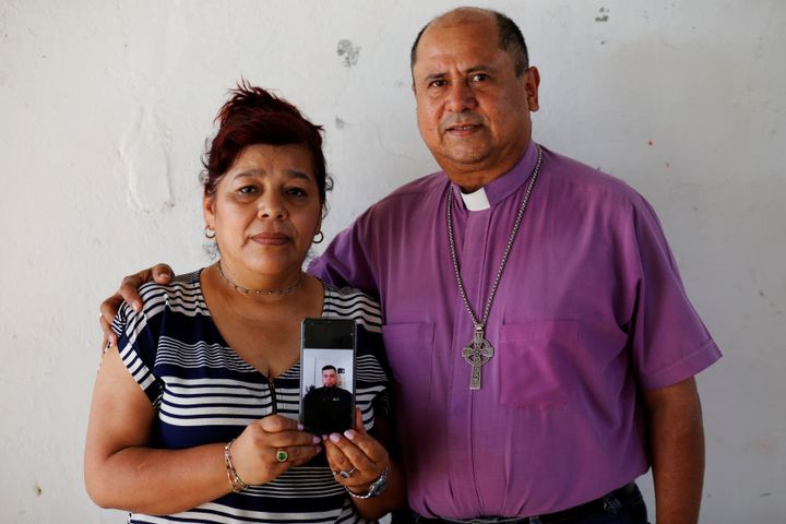 Rev. Irma de Alvarado and Bishop David Alvarado, of the Anglican Episcopal Church in El Salvador, show a picture of their son Josue Alvarado Guerra, who was apprehended by U.S. authorities in November 2019. 