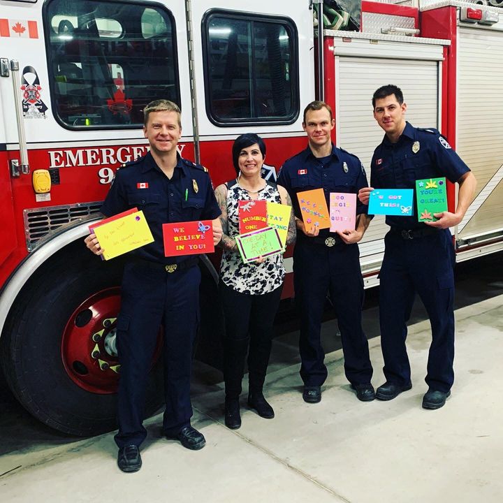 Harris poses with some of the firefighters who made cards.