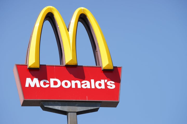 Ljubljana, Slovenia - September 3, 2011: Close-up of McDonalds outdoor sign with typical rounded yellow M letter against cloudless blue sky. Sign is positioned on the left side of image.
