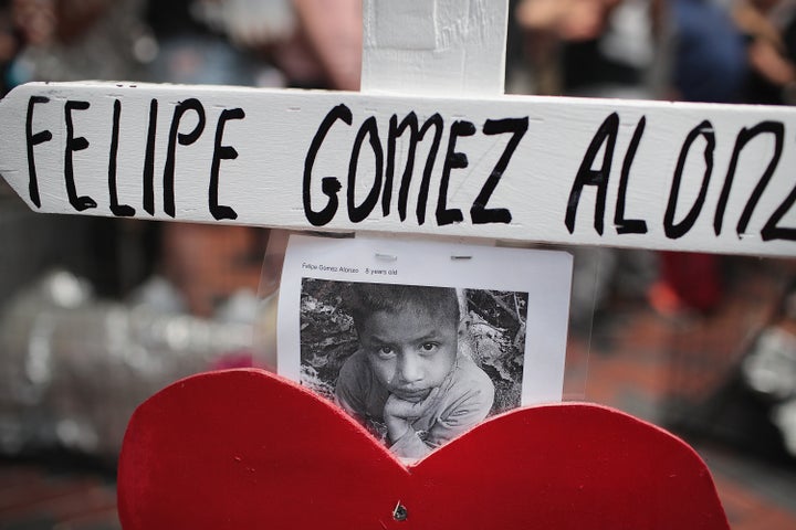 A cross memorializing a child who died while in custody of U.S. Customs and Border Protection sits across from the Marriott Marquis hotel as protestors demonstrate on July 23, 2019, in Chicago.