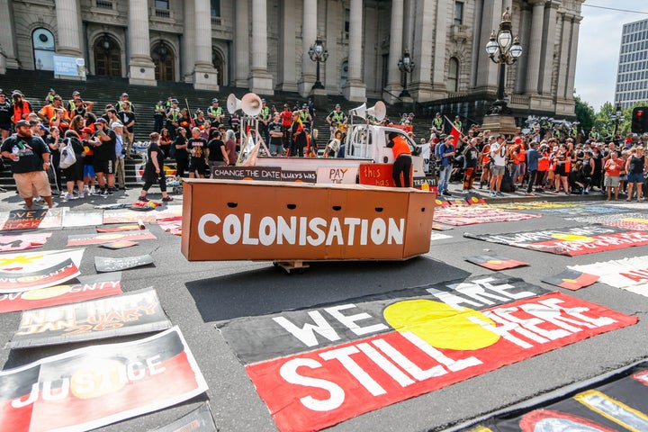 A mock coffin with 'Colonisation' written on it surrounded by placards out the front of Victorian Parliament house during a protest by Aboriginal rights activist on Australia Day in Melbourne, Australia 26 January 2018. Australia Day is named by some as Invasion Day due to the dispossession of Indigenous land and the arrival of the First Fleet's at Port Jackson, Sydney, in 1788. 