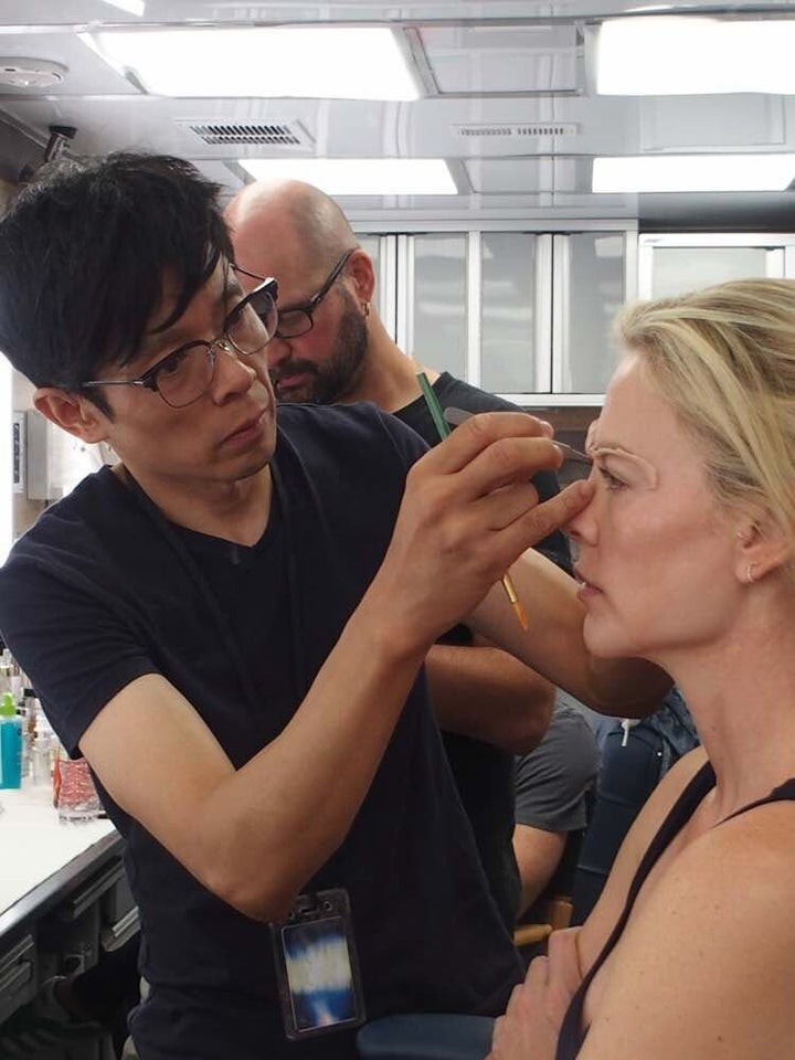 Kazu Hiro applying prosthetics to actor Charlize Theron.