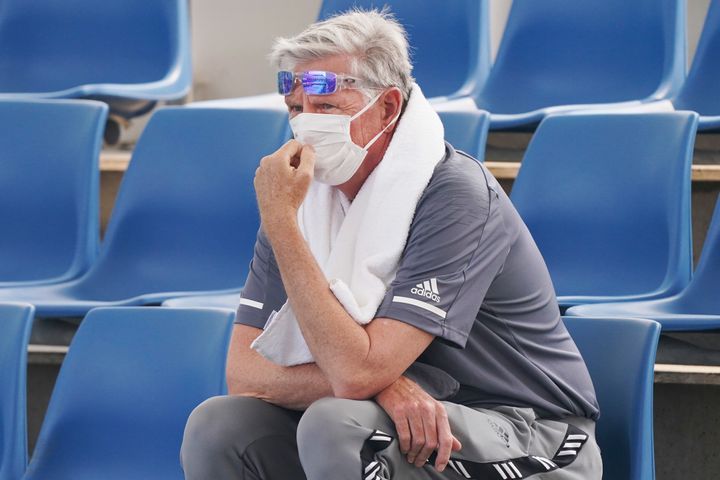 A spectator wears a mask as smoke haze shrouds Melbourne during an Australian Open practice session at Melbourne Park in Australia, Tuesday, Jan. 14, 2020. Smoke haze and poor air quality caused by wildfires temporarily suspended practice sessions for the Australian Open at Melbourne Park on Tuesday, but qualifying began later in the morning in "very poor" conditions and amid complaints by at least one player who was forced to forfeit her match. (Michael DodgeAAP Image via AP)