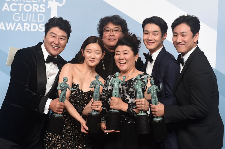 The cast of Parasite celebrate their win with director Bong Joon-ho