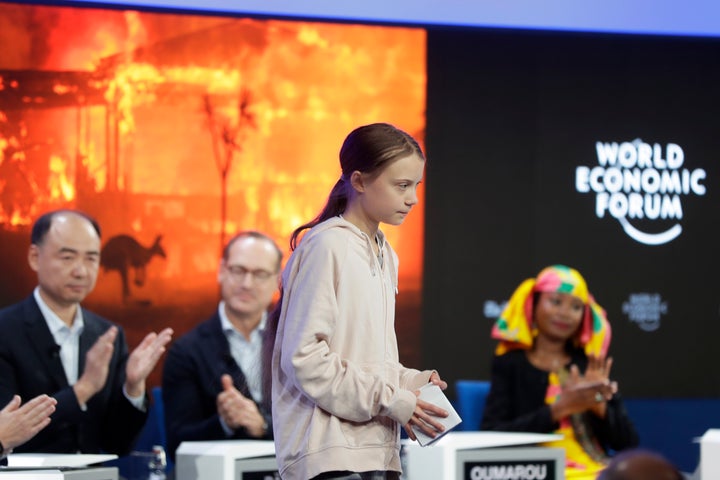 Panel members applaud for Greta Thunberg after she addressed guests at the forum's 50th annual meeting in Davos.