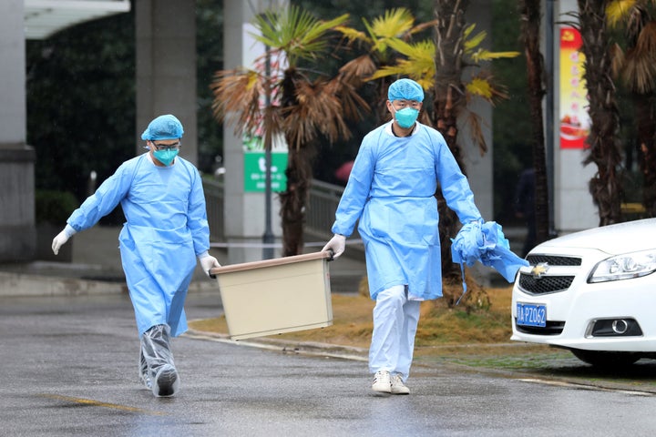 Medical staff carry a box as they walk at China's Jinyintan hospital, where patients with pneumonia caused by the new strain of coronavirus are being treated, in Wuhan, Hubei province.