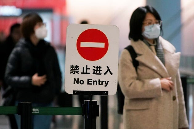 Passengers wearing masks are seen at Hongqiao International Airport in Shanghai, China January 20, 2020.