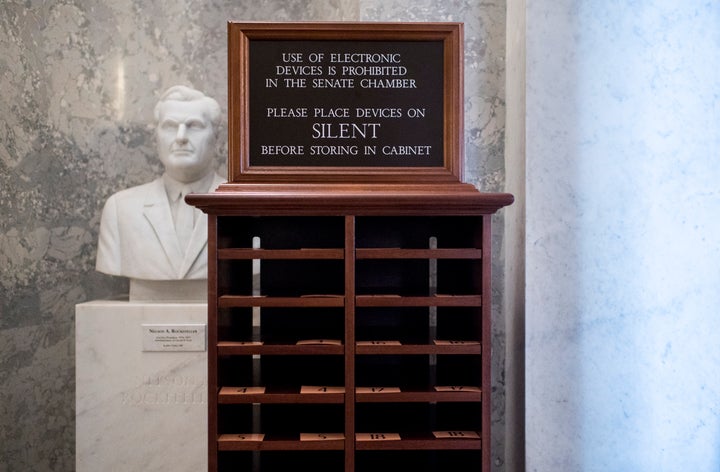 A storage unit for phones stands next to the entrance of the Senate chamber on Tuesday, Jan. 21. Electronic devices are not allowed in the chamber for the Senate impeachment trial.