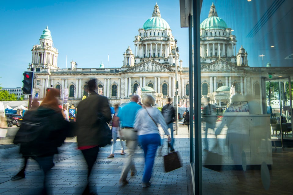 Motion blurred shoppers in front of Belfast city hall in Northern Ireland