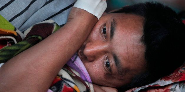 A Nepalese victim of an earthquake rests at Teaching Hospital in Kathmandu, Nepal, Tuesday, May 12, 2015. A major earthquake has hit Nepal near the Chinese border between the capital of Kathmandu and Mount Everest less than three weeks after the country was devastated by a quake. (AP Photo/Niranjan Shrestha)