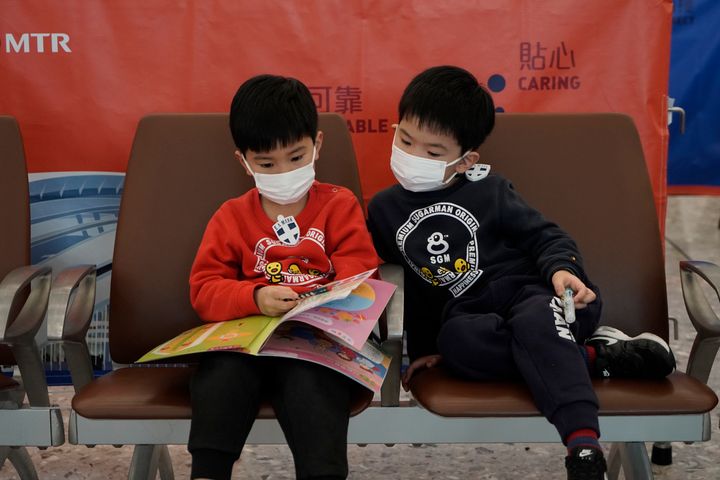 Passengers wear masks to prevent an outbreak of a new coronavirus in the high speed train station, in Hong Kong on Wednesday.