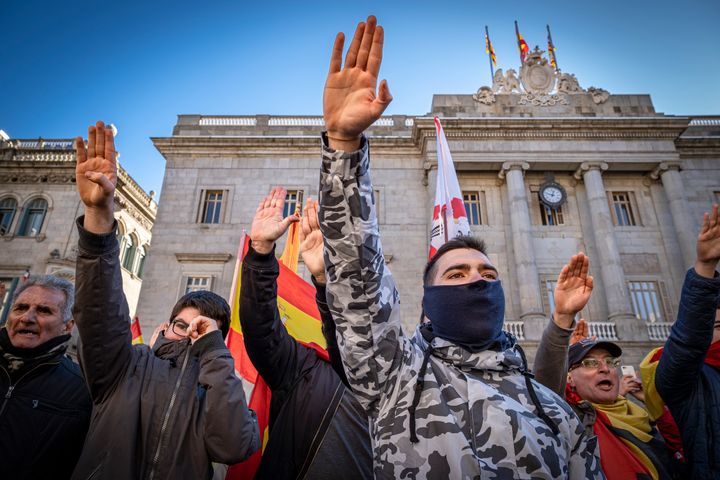 Vox supporters sing the anthem of the Spanish Phalanx while making the fascist salute during a Jan. 12 protest in Barcelona.