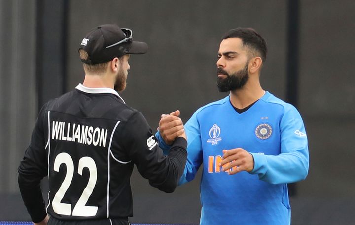 Virat Kohli congratulates New Zealand's captain Kane Williamson for winning their Cricket World Cup semifinal match, July 10, 2019.