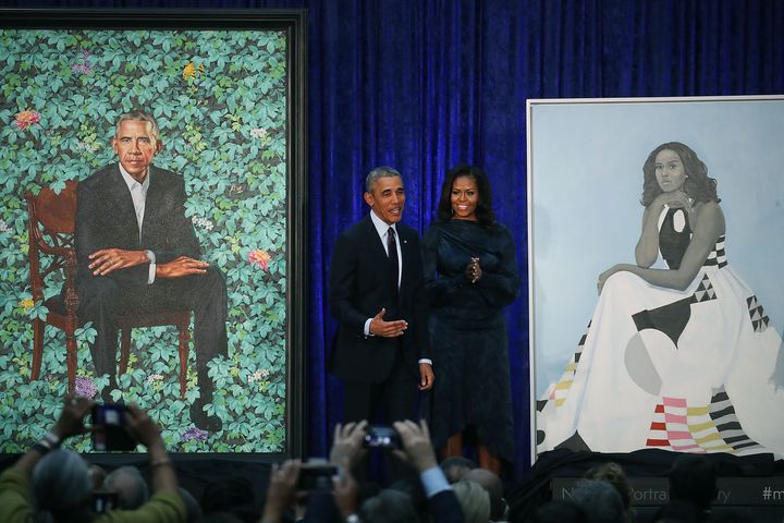 Former U.S. President Barack Obama and former first lady Michelle Obama stand next to their newly unveiled portraits during a ceremony at the Smithsonian's National Portrait Gallery in February 2018 in Washington, D.C. Kehinde Wiley created the former president's portrait and Amy Sherald did that of Michelle Obama.