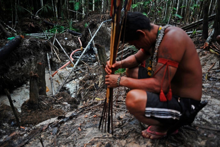 Munduruku warriors arrive at an area of jungle cleared by wildcat gold miners as they search for illegal gold mines and miners in their territory.