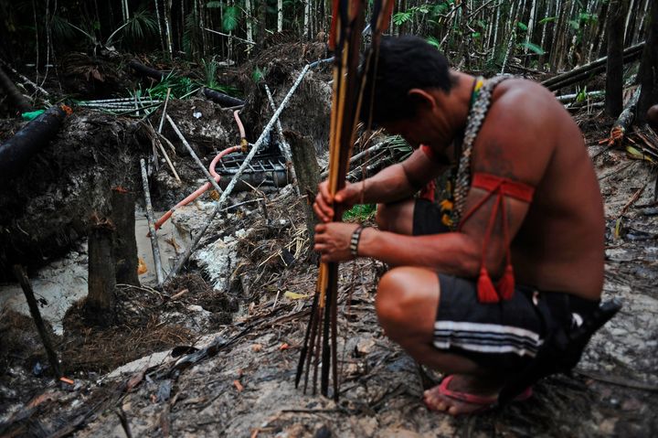 Munduruku warriors arrive at an area of jungle cleared by wildcat gold miners as they search for illegal gold mines and miners in their territory.
