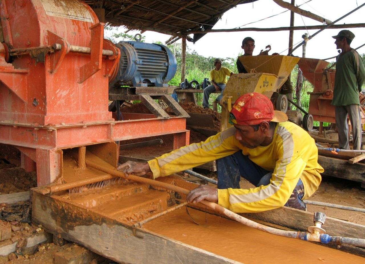 A Brazilian gold miner cleans a rock crusher in Bom Jesus along the Tapaj´s River.