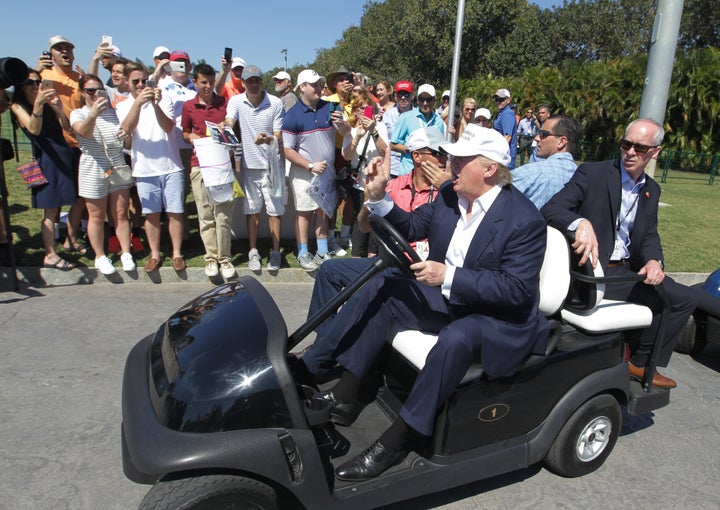 Then-presidential candidate Donald Trump drives himself around the golf course to watch the final round of the Cadillac Championship golf tournament on March 6, 2016, in Doral, Florida.