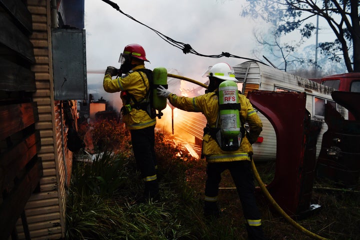 Rural Fire Service firefighters extinguish a fire on a property on January 23, 2020 in Moruya, Australia. (Photo by Sam Mooy/Getty Images)