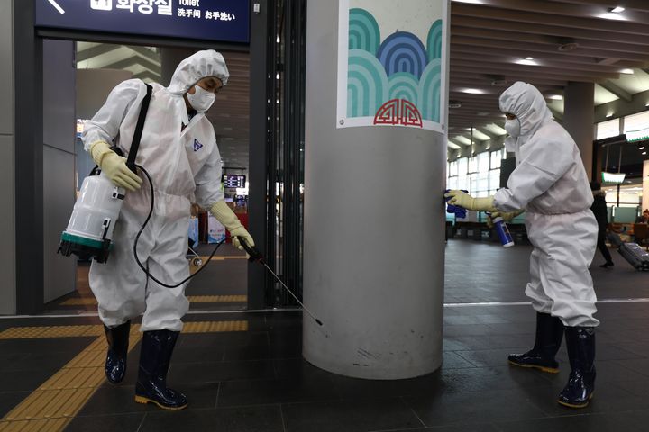 Disinfection workers wearing protective gears spray anti-septic solution in an train terminal amid rising public concerns over the spread of China's Wuhan Coronavirus at SRT train station on January 24, 2020 in Seoul, South Korea. 