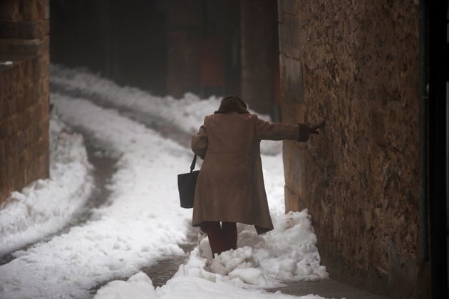  A woman walks during the storm 