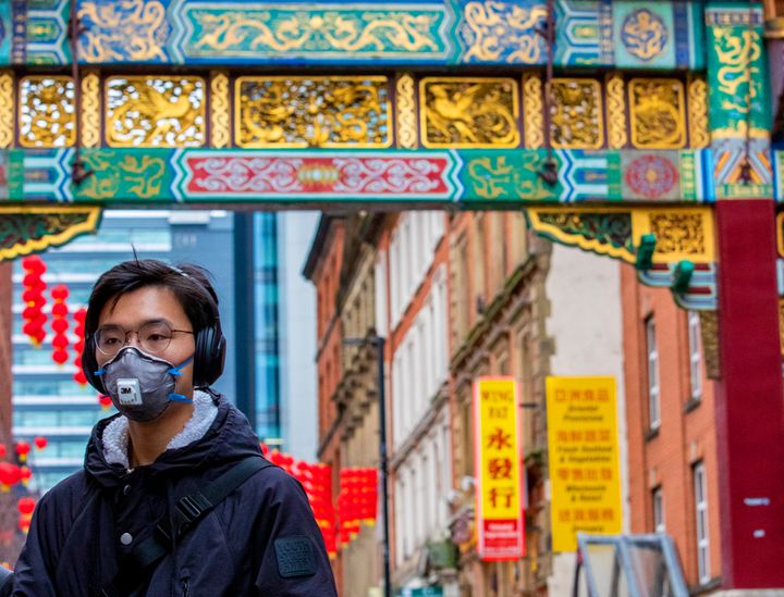 A passerby wearing a face mask in Manchester's Chinatown 