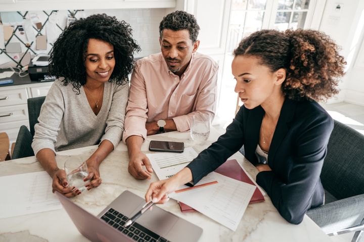 An accountant is seen here explaining mortgage payment options to a couple in this stock photo. There's no right or wrong decision when it comes to what kind of mortgage you choose, but there are pros and cons to each.