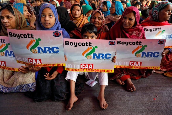 Demonstrators display placards as they attend a protest against a new citizenship law in Shaheen Bagh, area of New Delhi, India, January 14, 2020. REUTERS/Adnan Abidi