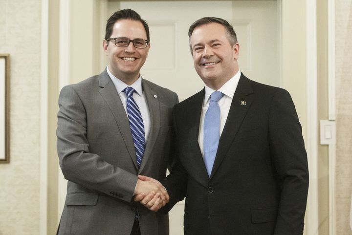 Alberta Premier Jason Kenney shakes hands with Demetrios Nicolaides, Minister of Advanced Education after being sworn into office, in Edmonton on Tuesday April 30, 2019. 