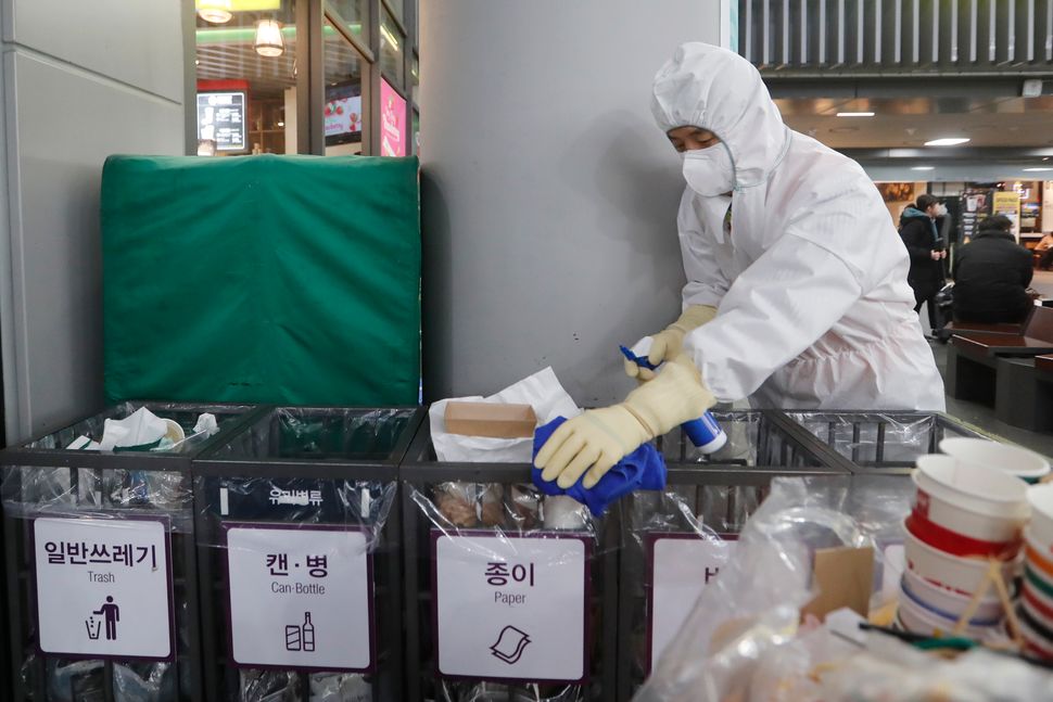 An employee works to prevent a new coronavirus at Suseo Station in Seoul on Friday.