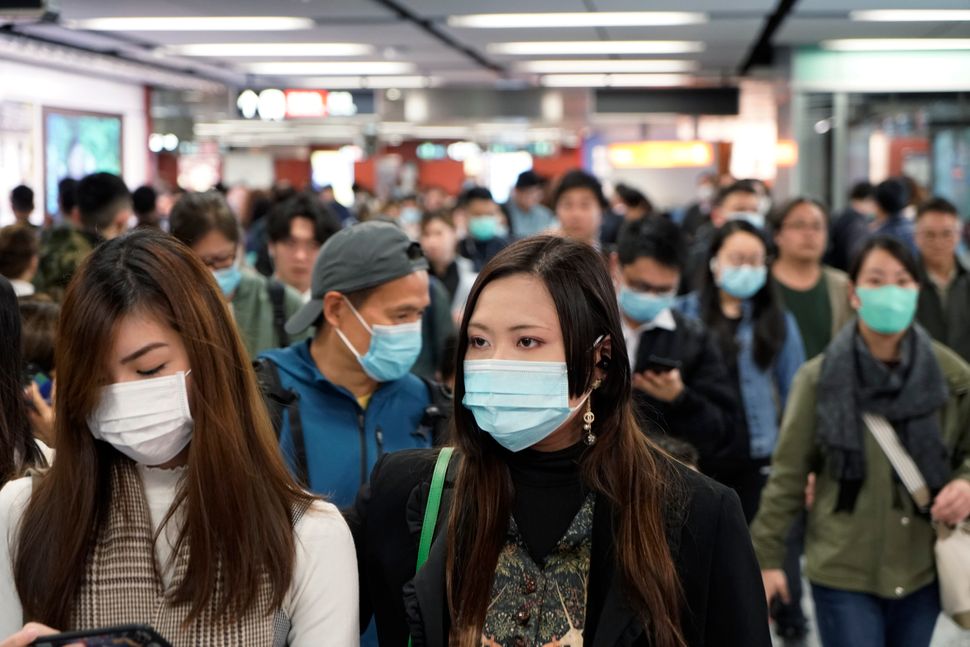 Passengers wear masks amidst an outbreak of a new coronavirus in a subway station in Hong Kong on Wednesday.