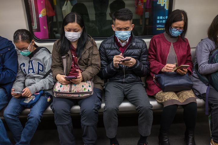 People wear masks on a train on the first day of the Lunar New Year.