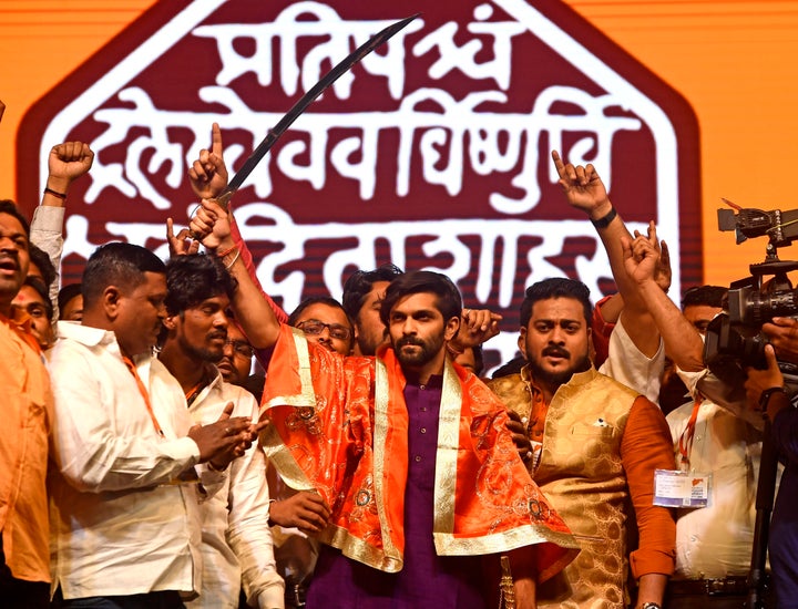 Raj Thackerays son Amit Raj Thackeray holds a sword presented to him during the party's convention at NESCO in Goregaon, on January 23 in Mumbai.. Amit was introduced as a leader of the MNS party at the event in which the MNC also got a new flag