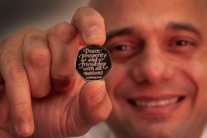 Sajid Javid holding the Brexit coin, a 50p bearing the inscription 'Peace, prosperity and friendship with all nations' and the date the UK leaves the EU.