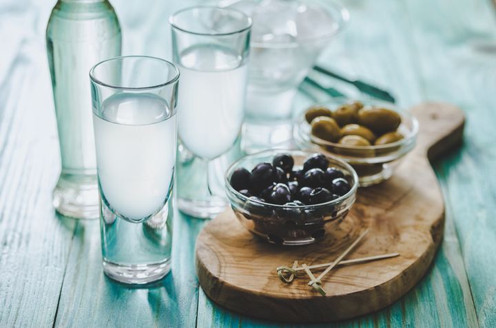 Favorite Greek summer drink Ouzo, flavor liquor made with the anise plant , served with Kalamata olives