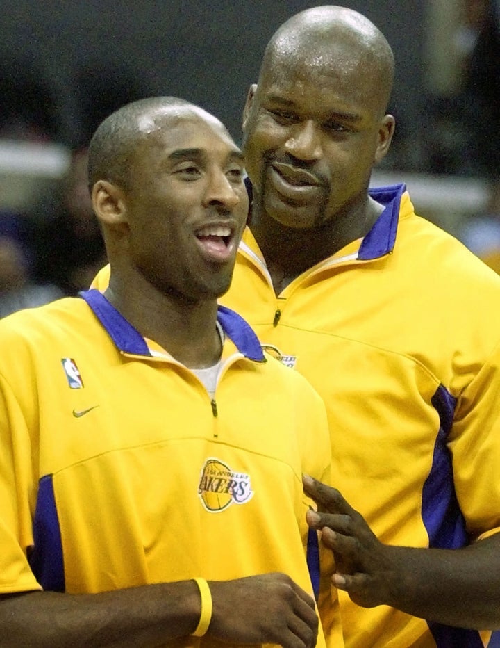 O'Neal jokes with his teammate and rival Bryant before their NBA game against the Detroit Pistons in Los Angeles on Nov. 14, 2003.