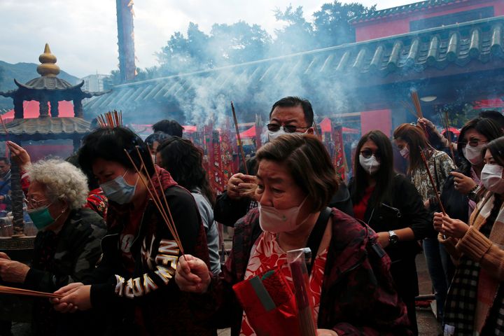 Worshippers wear masks to prevent an outbreak of a new coronavirus as they make offerings of incense sticks during a Lunar New Year celebration at Che Kung Temple, in Hong Kong, January 26, 2020. 