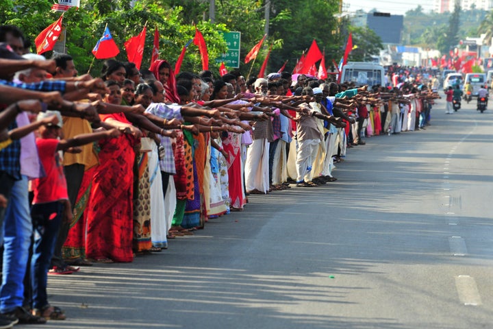 People line up along a road to form a 620 km human chain across Kerala organized by the Left Democratic Front (LDF) to protest against the Citizenship Amendment Act (CAA), Thiruvananthapuram on January 26, 2020. 