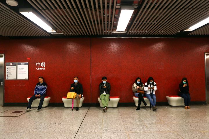 Passengers wait for the subway wearing face masks following reports of the coronavirus appearing in Hong Kong. 