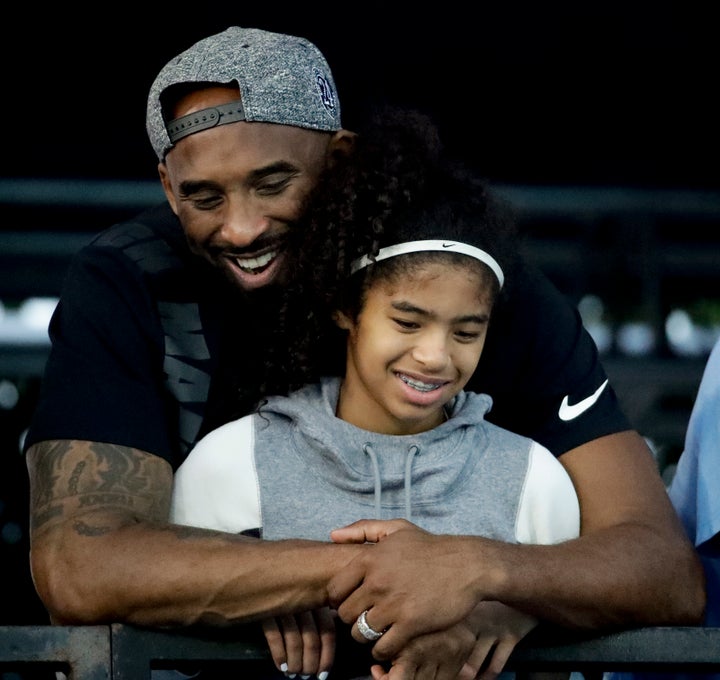 In this July 26, 2018 file photo former Los Angeles Laker Kobe Bryant and his daughter Gianna watch during the U.S. national championships swimming meet in Irvine, Calif.