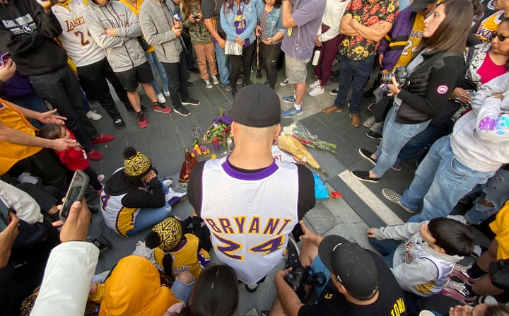 Fans mourn the loss of Kobe Bryant with makeshift memorials in front of La Live across from Staples Center, home of the Los Angeles Lakers in Los Angeles on Sunday, Jan, 26, 2020. 